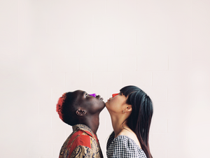 Two women touching chins with NÖZ sunscreen on their noses.