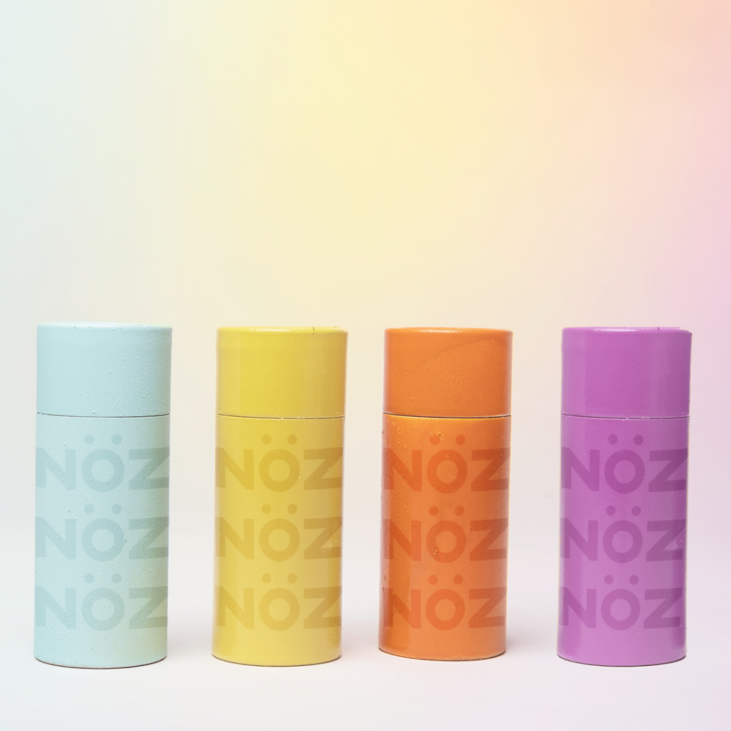 blue, yellow, orange, and purple NÖZ sunscreens containers lined up