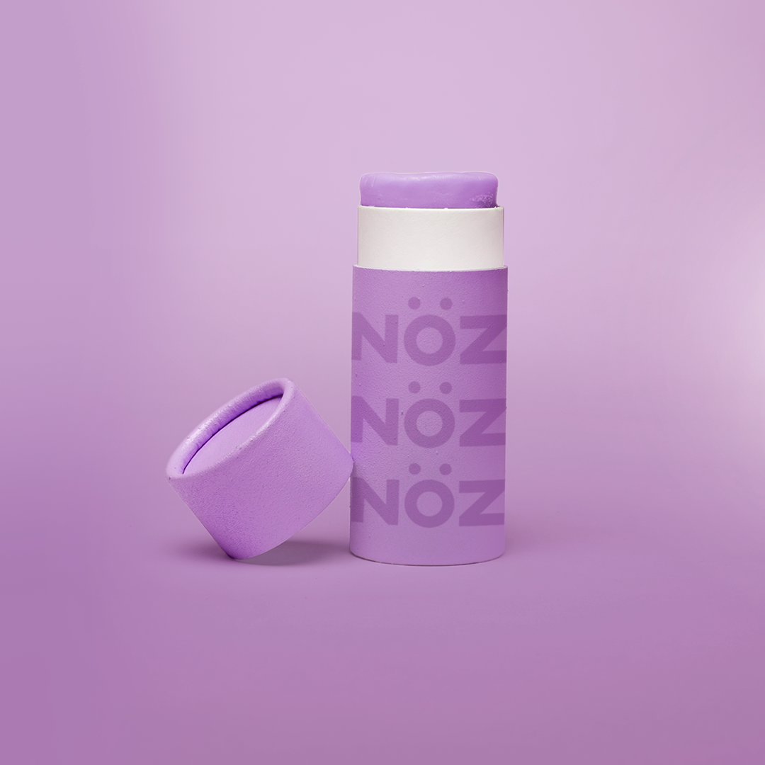 Purple NÖZ container sitting open with the top off.