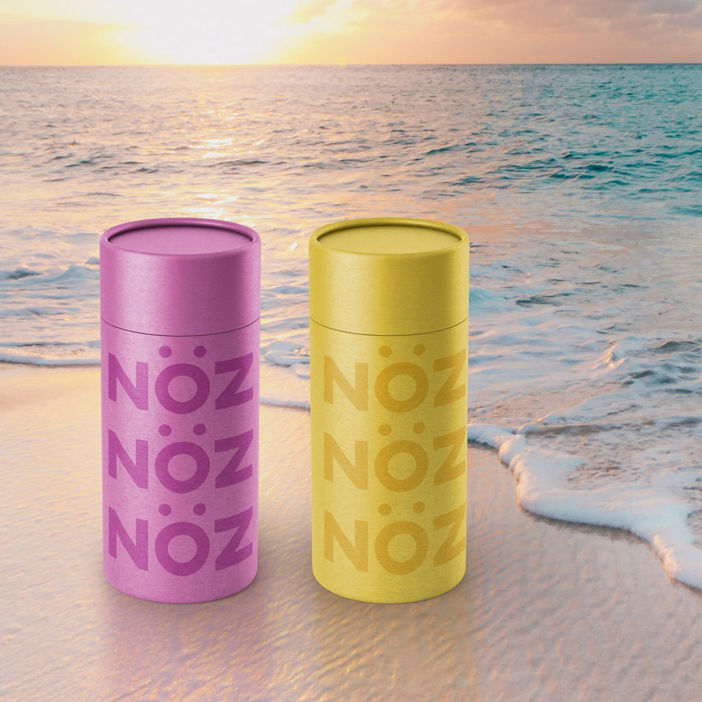 Purple and yellow NÖZ containers on the beach