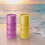 Load image into Gallery viewer, Purple and yellow NÖZ containers on the beach
